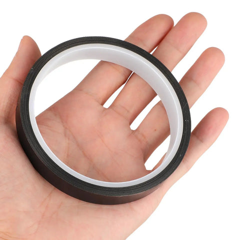 Hand holding High Temperature PTFE Heat Resistant Tape For Heat Transfer Applications, 1 Roll, One Half Inch Wide, Waterproof Black Tape