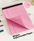 Close-up of pink 5x8 inch college ruled notepad with page flipping, showing 17 lines and details, 80gsm paper, ideal for notes.