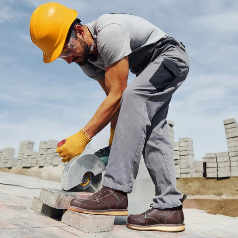 Construction worker cutting bricks wearing Six Inch Waterproof Moc Toe Steel Toe Work Boots For Men With Full Grain Leather