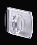 Close-up of Mini Clear Decorating Hook Clip with Adhesive Tape, ideal for damage-free hanging, transparent 0.71 by 0.51 inches.