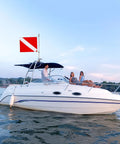 Boat on ocean with 20 X 24 Inch Dive Flag With Removable Stiffening Pole For Scuba Diving Freediving And Spearfishing Red And White Diver Down Boat Flag US Legal Size Pro Grade Visibility For Ocean Waters And Safe Boating mounted on pole