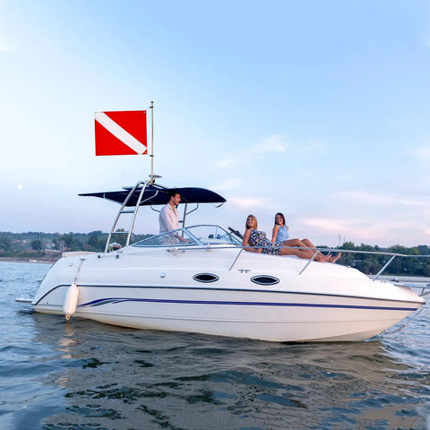 Boat on ocean with 20 X 24 Inch Dive Flag With Removable Stiffening Pole For Scuba Diving Freediving And Spearfishing Red And White Diver Down Boat Flag US Legal Size Pro Grade Visibility For Ocean Waters And Safe Boating mounted on pole
