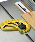 Hedgehog featherboard for table saw; yellow plastic body with black knob, guides wood during ripping.