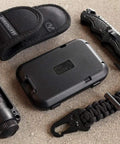 RFID Blocking 4 Card Wallet with 3 scan proof card slots alongside survival gear on textured surface
