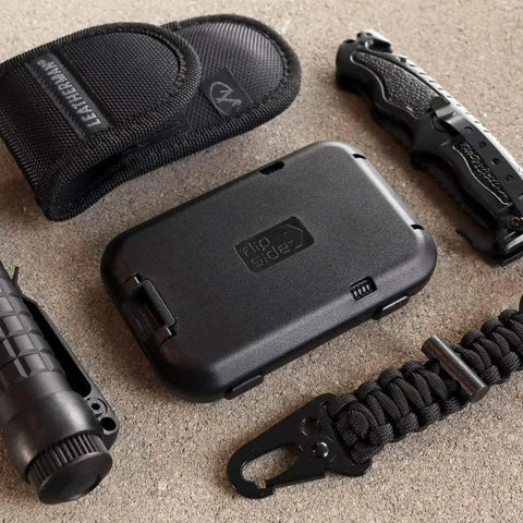 RFID Blocking 4 Card Wallet with 3 scan proof card slots alongside survival gear on textured surface