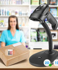 Portable Wireless 1D 2D Barcode Scanner With Stand For Quick Paper And Screen Scans on counter next to a package at a POS setup.
