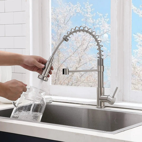 Brushed Nickel Kitchen Faucet With Pull Down Sprayer in use over stainless steel sink, spring design, single handle, modern style