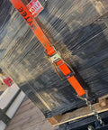 4 Pack 2 Inch Orange Ratchet Straps With Chain Anchors 4000 Lbs WLL securing cargo on trailer with black wrapped bundle