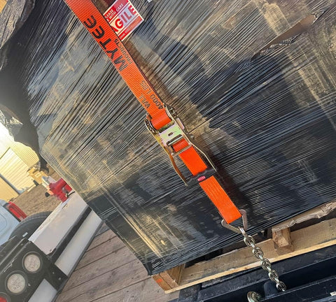4 Pack 2 Inch Orange Ratchet Straps With Chain Anchors 4000 Lbs WLL securing cargo on trailer with black wrapped bundle