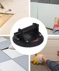 Heavy Duty Glass Suction Cup Lifter With Quick Release Handle For Moving Granite, Ceramic Tile, And Sheet Metal Safely Made Of Sturdy Nylon And Rubber For A Smooth Twist Tight Vacuum Grasp displayed during tile installation.