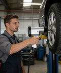 Knuckle Buster 71 Piece Pneumatic Air Tool Kit Featuring 1/2 Inch Impact Wrench in use on a car tire by a mechanic.