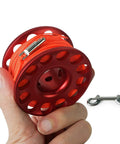 Hand holding compact aluminum 98ft Diving Finger Reel With Line And Snap For Scuba Wreck Cave Tech Diving Snorkeling Kayak Anchor.