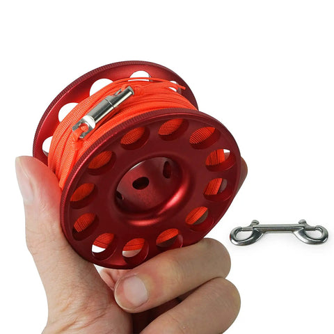 Hand holding compact aluminum 98ft Diving Finger Reel With Line And Snap For Scuba Wreck Cave Tech Diving Snorkeling Kayak Anchor.