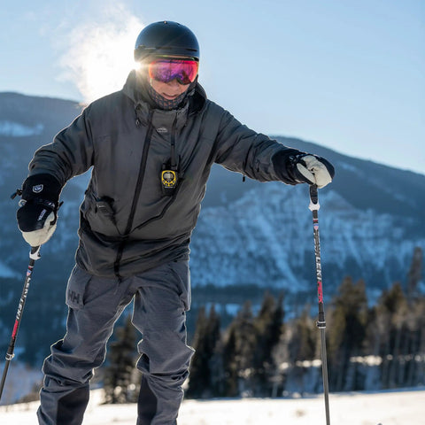 Person skiing with Push To Talk Handheld And Wearable Speaker Microphone Set for GMRS Radios, clear audio, easy clip on jacket