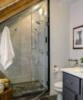 Modern bathroom with Neo Pressure Balance Shower Valve Trim in Brushed Nickel, glass shower enclosure, and towel.