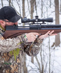 Person aiming Viriatus 2.0 BP PCP Air Rifle 177 Caliber With 1020 FPS Velocity And Lothar Walther Barrel in snowy forest
