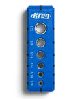 Kreg portable drilling guide, blue plastic block with multiple metal drill bushings and size markings.