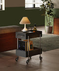 Ride Smooth Black Two Tier Mobile Bar Cart With Secure Roller Wheels Home Serving Stand Kitchen Drink Station Glass Top Steel Rack Casual Flex Storage beside a sofa.