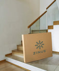 Dead Simple 9 Inch Box Spring With Built Tough Steel Core And Pristine White Cover Ultimate Mattress Foundation For Split California King Beds That Opens In A Flash in large packaging on stairs.
