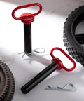 2 Pack 1 Inch Clevis Hitch Pins With Red Rubber Coated Handle and 3.35 Inch R Clip Black Powder Coated for Ball Mounts ATV and Hitch Accessories displayed on a surface.