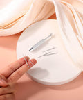 Piercing Ball Grabber Tool For Changing Jewelry Stainless Steel Diamond Claw Tweezers with insertion pins on round platform.