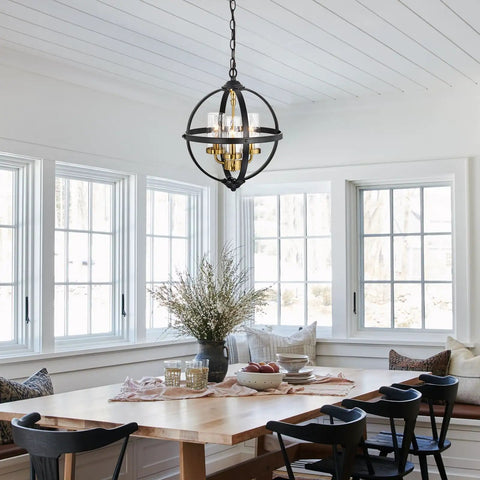 Rustic Farmhouse Chandelier 14-Inch Globe Pendant Light In Vintage Black And Gold hanging in a cozy dining room setting