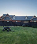 House exterior with 10x16 Foot 10oz Multi Mesh Tarp PVC Coated Polyethylene Shade Roll Off Heavy Duty Black Mesh for shade