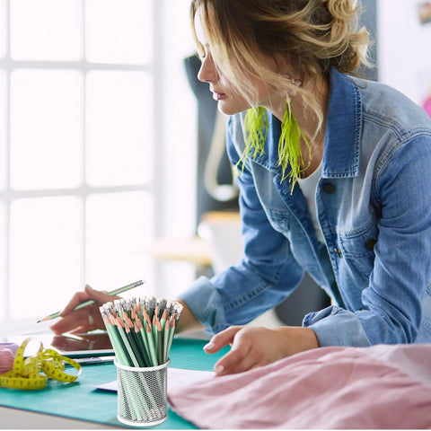 Person using 60 Pcs HB Pencils No 2 Unsharpened Wood Cased Pencils with Erasers Hexagonal Green Barrel Red Erasers at a desk