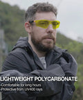 Man wearing Yellow Lens Safety Glasses With Blue Light Blocking And Night Vision Enhancement For Shooting, Gaming And Low Light Work
