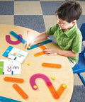 Child playing with Number Construction Kit For Kids 3 Plus With 55 Pieces, Snap Together Color Coded Numbers 0 Through 9 on table.