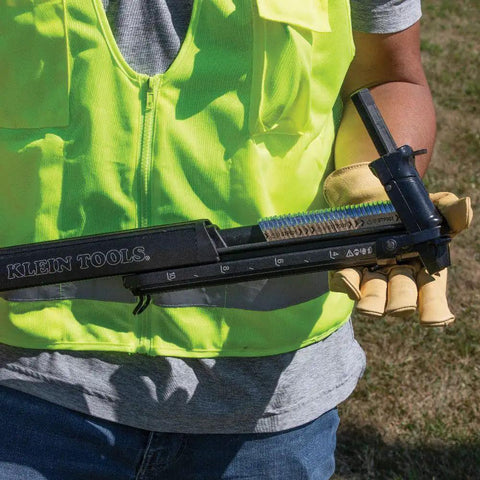 Worker holding Klein Tools Utility Staple Starter with Beefy Heavy Duty Staples For Ground Wire And Molding Installations 480 Pack