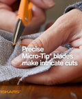Hands using Premier No 5 Micro Tip Orange Handled Fabric Scissors With Double Loop Handle for precise cuts on fabric.