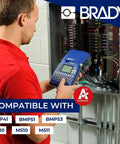 Person using label maker in front of electrical panel, compatible with BMP41, BMP51, M510, and M511.