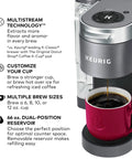 K Supreme Single Serve K Cup Pod Coffee Maker With MultiStream Technology Delivering Rich Flavor For Every Cup beside a red mug