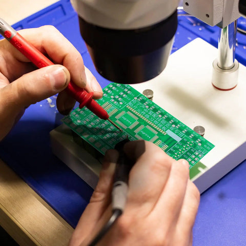 Hands On Solder Practice Board Kit For SMD Circuit Welding Training With Double Sided PCB in use under a microscope.