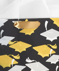 Medium Graduation Gift Bag with Tissue Paper featuring gold and silver mortarboards on black for college high school eighth grade kindergarten.