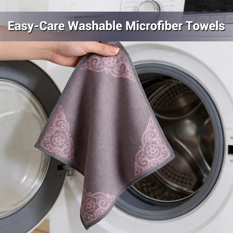Microfiber cleaning cloth, gray with pink corner floral pattern, hand-held beside a front-loading washing machine.