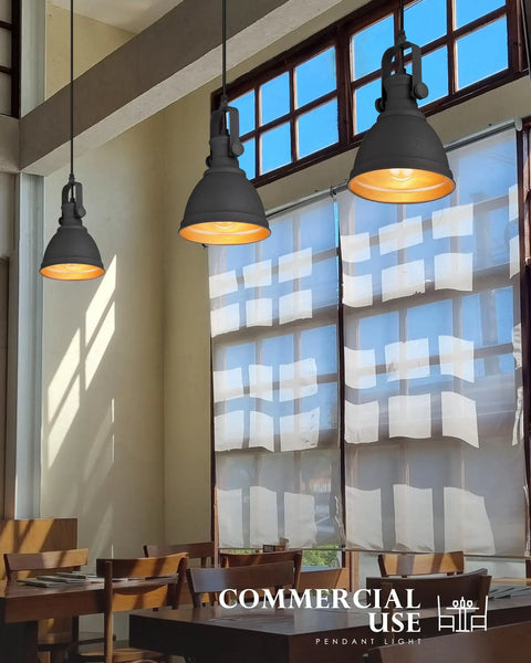 Sunrise Inspired Modern Pendant Lights Set Of 2 Black And Orange Gold Metal Hanging Fixtures For Kitchen Island With Sanded Texture Finish Industrial Urban Style AD 2151 1P2 hanging in a dining room.