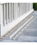 Removable Channel Drain System With Grates For Outdoor Pathways Courtyards Lawn And Driveways Built To Handle Beefy Heavy Duty Load And Seasonal Weather Stainless Steel Trench Drainage Solution With Hidden Grate And Easy Cleanout installed alongside white railing