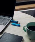 Rock Solid 16Gb Encrypted Usb Drive With Alphanumeric Keypad Lock next to laptop and coffee cup on table.