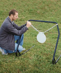 Man setting up Replacement Magnum Rifle Gong With AR550 Steel Construction for outdoor range shooting and hunting