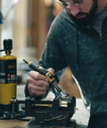 Person using Pro Grade Precision Flame Hand Torch With Adjustable Heat For MAP Pro Propane Fuel on metal project in workshop.
