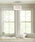 Sienna 15 Inch Sleek Modern Lattice Drum Semi Flush Mount Ceiling Light 3-Light Silver Finish in cozy window seat area.