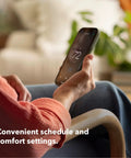 Person adjusting Energy Star Certified Programmable WiFi Thermostat That Works With Siri, Alexa And Google Assistant via smartphone app