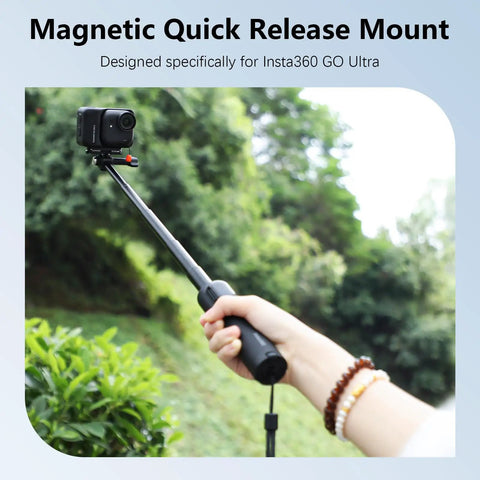 Person holding a selfie stick with Magnetic Quick Release Adapter Mount for Insta360 GO Ultra in outdoor setting.