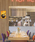 Restaurant interior with Funny Vintage Metal Sign Featuring Steaming Bowl Of Ramen Illustration Tin Sign on wooden wall.
