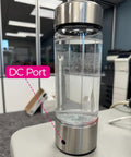 Hydrogen Water Generator Bottle Charging Cable USB To DC Charger Cord connected to DC port on bottle, shown in office.