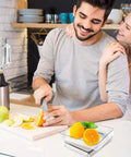 Couple preparing fruit in kitchen with Ultra Dope Digital Kitchen Scale and stainless tray on counter