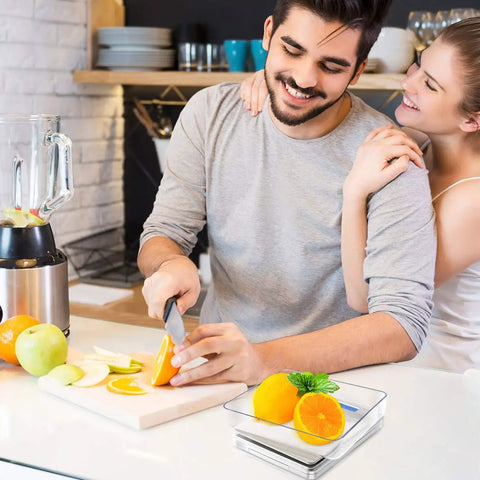 Couple preparing fruit in kitchen with Ultra Dope Digital Kitchen Scale and stainless tray on counter