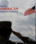 Silhouette of a soldier saluting an American flag against a cloudy sky, with text reading 'Proudly American Owned & Operated'.